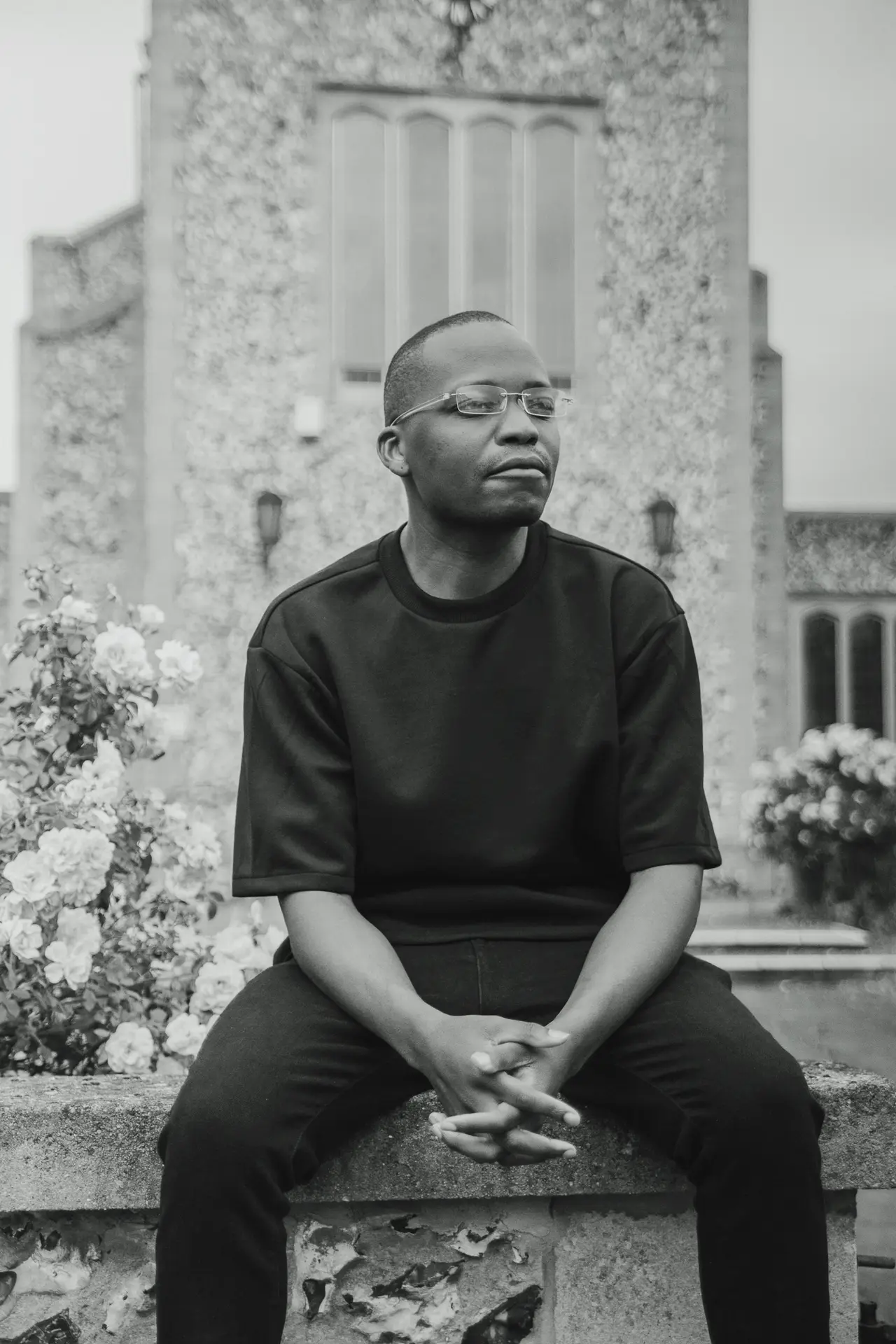 Tobi Tokz sitting outside a stone church