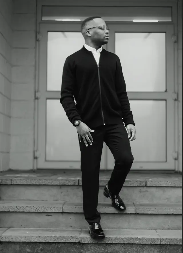Tobi Tokz standing on stone steps